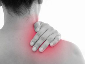 A person holding their neck and shoulder with visible redness, indicating pain, highlighting exercises and stretches for neck and shoulder pain relief.