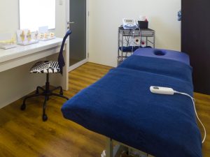 Modern chiropractic treatment table with ergonomic design in a professional therapy room, equipped for decompression and adjustments
