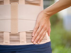 A back support belt designed to relieve pain from lifting and scoliosis, featuring adjustable straps for a secure fit. Ideal for individuals seeking support during heavy lifting or daily tasks.