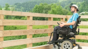 An MS patient using electric wheelchair as he has weak muscles and unable to self propell.