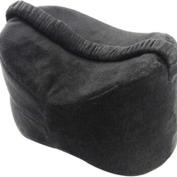 black contoured leg pillow with a curved ergonomic shape and soft fabric, designed to support knees or legs while sleeping