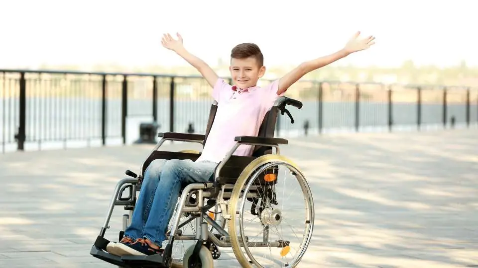 A young kid on a folding wheelchair model showing a great posture.