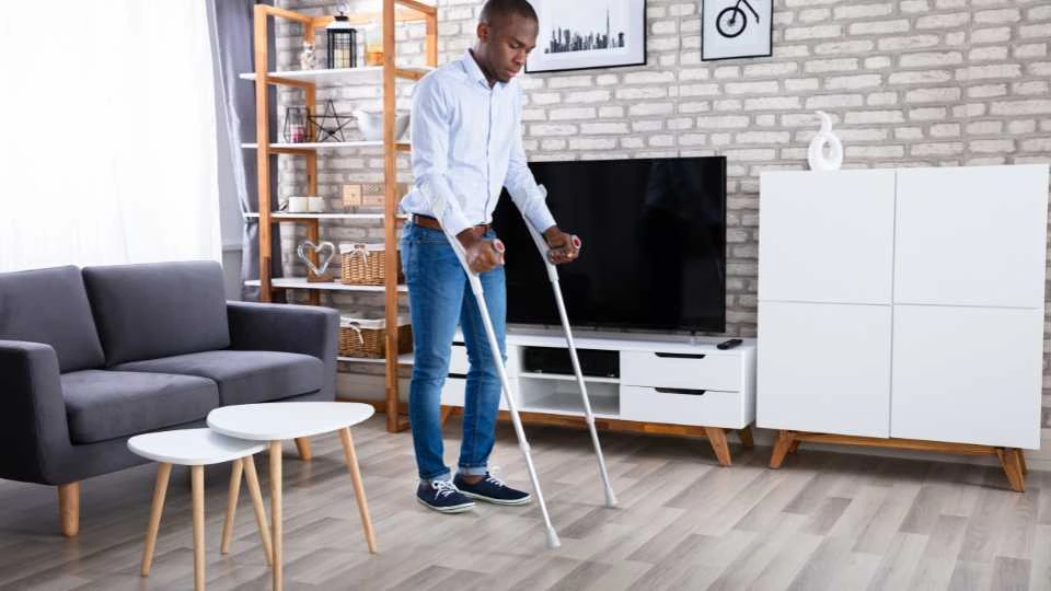 Young male using crutches at home as he preferred the more affordable option. Knee walker would've been a better option as his flat is very spacious.