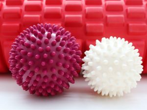 Plantar fasciitis massage ball for foot therapy, designed to relieve pain and tension in the ball of the foot. Learn how to use a spiky massage ball for foot and shoulder relief.