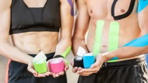 Young couple using kinesio tape and showing different colours available like yellow, blue and red.