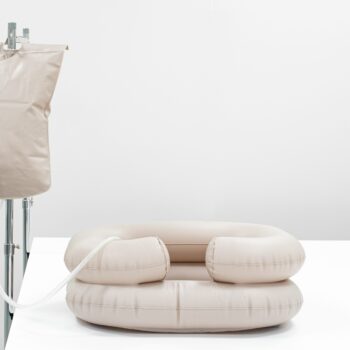 Inflatable PVC wash basin with portable water tank and shower hose on a stand