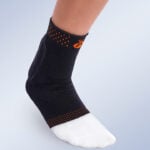 elastic ankle brace with heel cushion and achilles tendon support worn on foot for pain relief