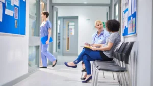 Inside a physio clinic. A physio specialist consulting with a patient in the corridor.
