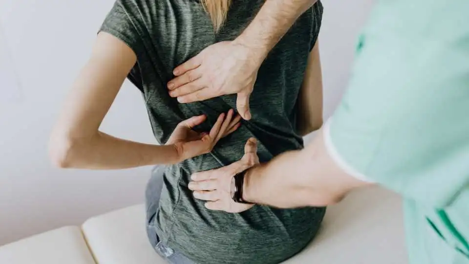 Young female visiting a physio expert to help her choose the right back support belt.