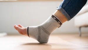 A woman using ankle support on her left foot.