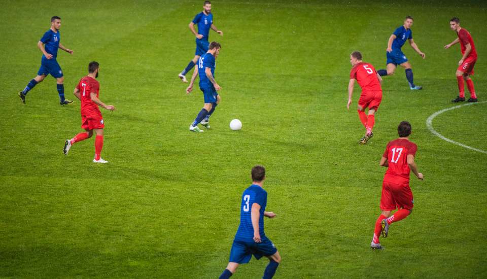 GAA players on the stadium chasing the ball.