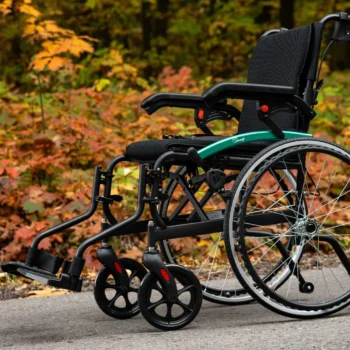 Lightweight self-propel wheelchair in an outdoor park setting, highlighting its portability, comfort, and suitability for outdoor mobility and independence.