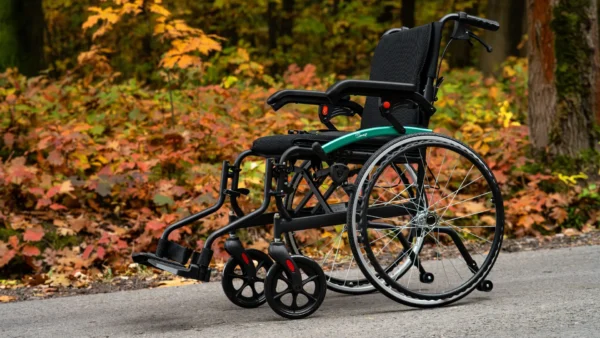 Lightweight self-propel wheelchair in an outdoor park setting, highlighting its portability, comfort, and suitability for outdoor mobility and independence.