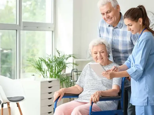 Care worker explains to an elderly couple and a lady with reduced mobility about incontinence aids.