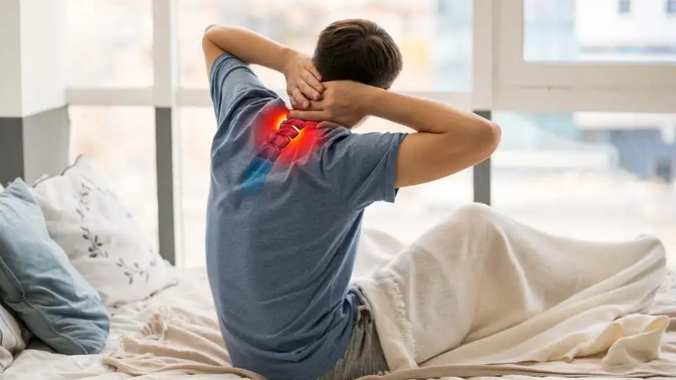A side sleeper who woke up with bad pain in his neck. Demonstrating the inflamed area.