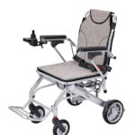 Grey electric wheelchair front-facing left, showing compact frame and modern joystick control – ideal for short trips and daily mobility.