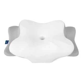 White sleep apnea pillow with a contoured surface and central depression, designed to support airflow and reduce pressure while sleeping.
