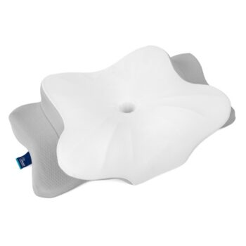 White sleep apnea pillow with a contoured surface and central depression, designed to support airflow and reduce pressure while sleeping.