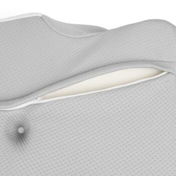 Close-up of a gray textured cushion cover with a zipper partially open, revealing inner foam.