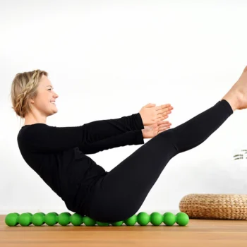 Person using the Sissel Spinefitter, lying back on dual pressure-point rollers for spinal relief