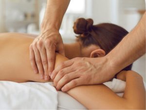 Massage therapist applying body massage cream to a client during a relaxing therapeutic session, highlighting the benefits for skin and relaxation.