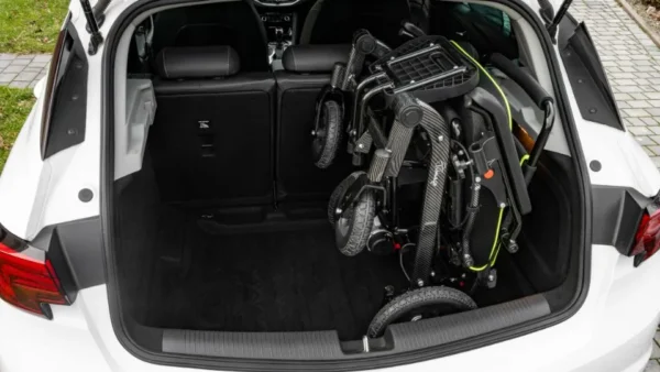 Folded electric wheelchair in car boot – perfect for travel and transport in Ireland.