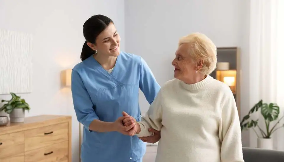A carer talking to a lady in the care home.