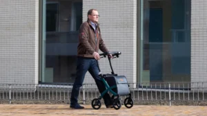 A senior using a rollator walker outdoors for shopping.