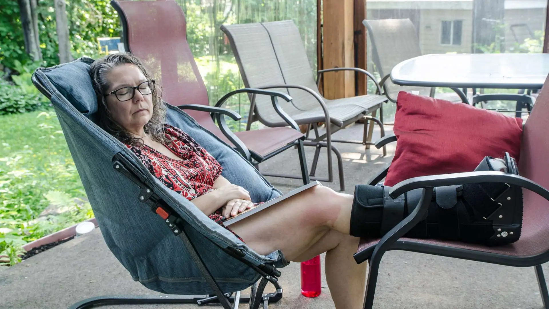 Elderly woman post ankle surgery wears an orthopaedic boot.