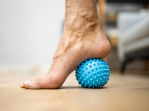 A handheld trigger point massage ball with spiky texture, designed to relieve muscle tension and target trigger points for pain relief and relaxation.