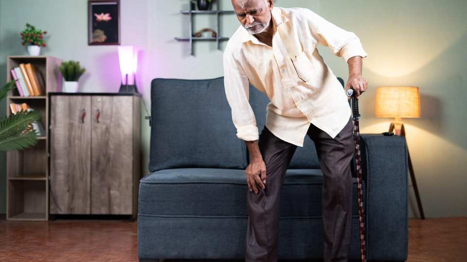 A senior using carbon walking stick at home. 