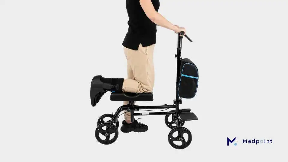 A man using a knee walker instead of crutches.