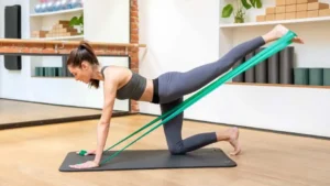 Young woman using resistance bands during a workout warm up.