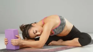Close-up of a woman practicing step-by-step yoga poses for beginners in a calm indoor setting, emphasizing guided yoga for relaxation and mindfulness