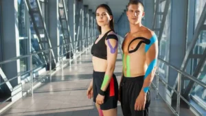 Image of young athletes using kinesio tape on their arms, chest and shoulders for extra support during workout.