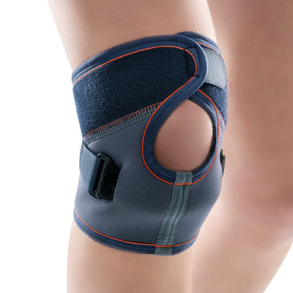 Close-up photo of a person wearing a Neoprene Kneecap Support Brace, showing comfortable, adjustable knee support with open patella design.