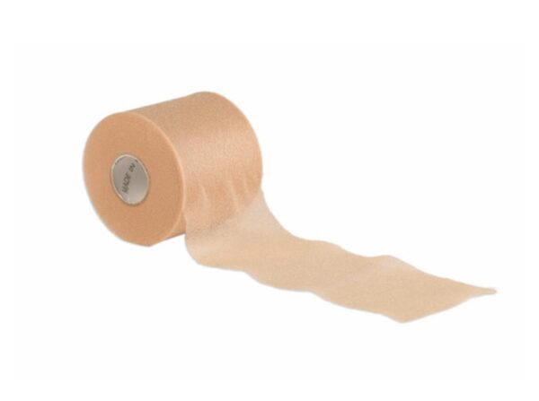 A single roll of tan-coloured pre-wrap foam tape partially unrolled, showing its thin, soft texture for use under adhesive bandages