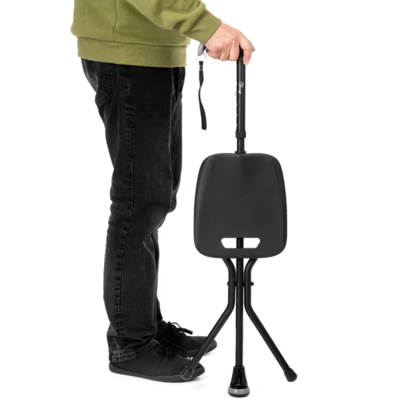 Person standing with walking stick with seat held by ergonomic handle