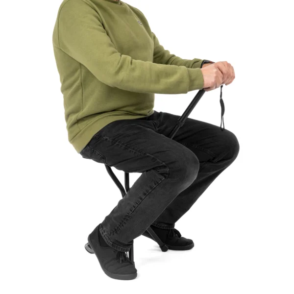 Person sitting on walking stick with seat showing safe usage